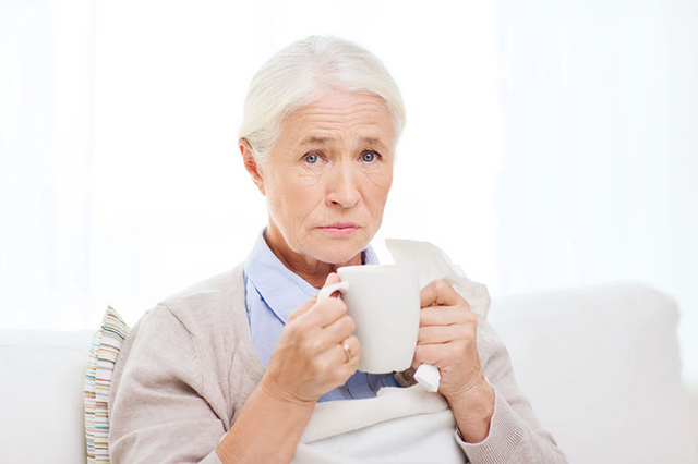 senior lady drinking from a mug